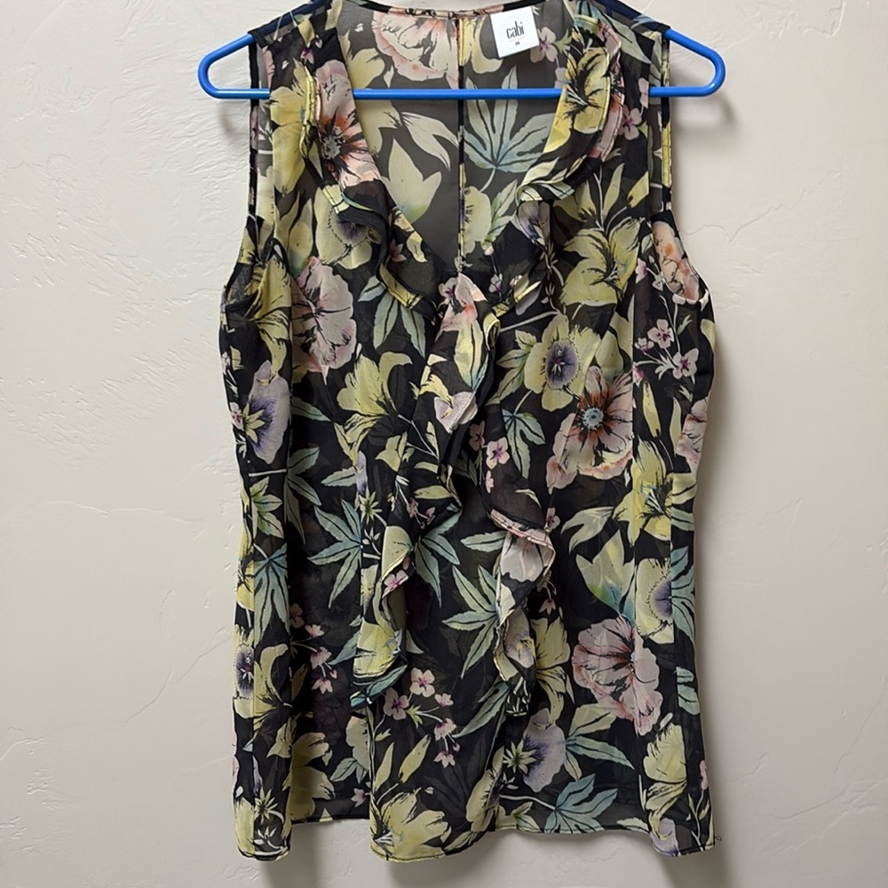 Cabi sleeveless top. Partially lined. Ruffle front. Pull on v neck. Black/multi